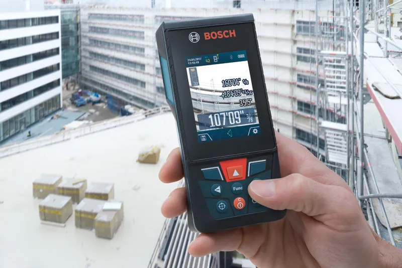 GLM 150 C Person using a laser measure on a building construction site.