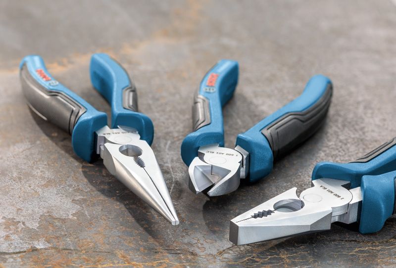 Plier Set 3 pcs Three-piece plier set with blue and black handles arranged on a metal surface.
