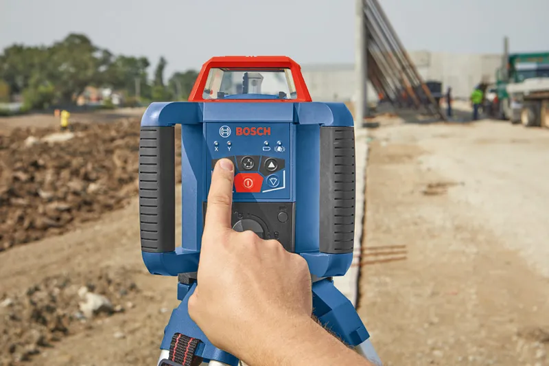 GRL 350 HV Person operating a laser leveling tool at a construction site.