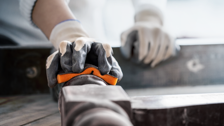 EXPERT S471 Standard Sanding Block, 26 x 69 x 97 mm, Medium, Fine, Super Fine, 3 pcs Person wearing safety equipment grips a metal pipe for alignment.