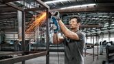 Man grinding metal frame.