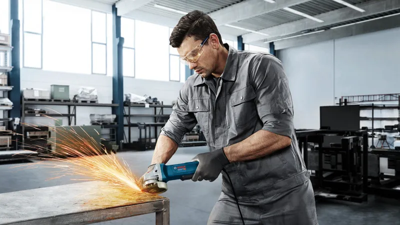 Man grinding metal table.