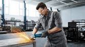 Man grinding metal table.