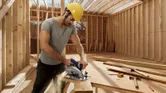 Man sawing wood construction.