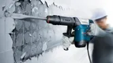 Bosch GSH 500 demolition hammer breaking wall tiles.