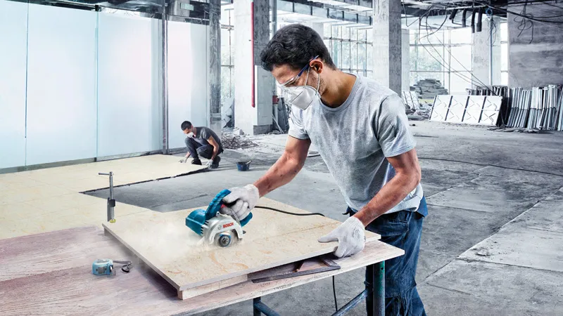 GDC 140 Bosch GDC 140 diamond tile cutter in use on a worksite.