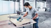 Bosch GDC 140 diamond tile cutter in use on a worksite.