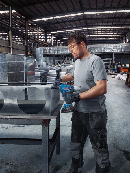 GRG 18V-16 C A person wearing safety equipment secures metal ductwork using a cordless rivet gun.