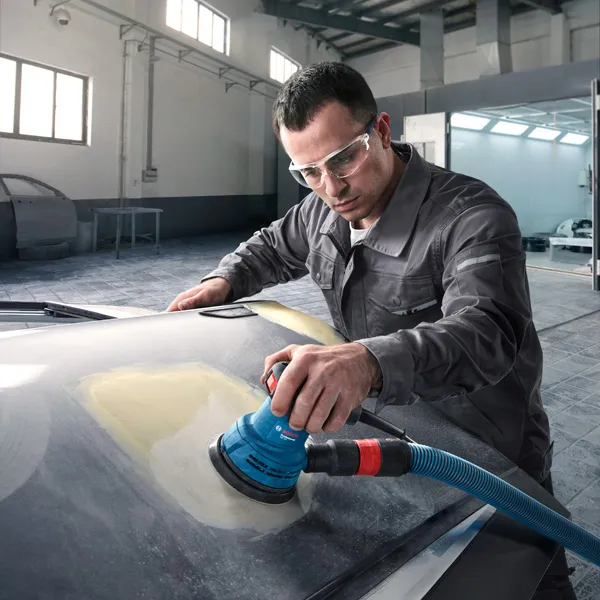 GEX 125 A person wearing safety equipment uses a random orbit sander on a car hood.