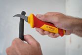 Person uses a curved electrician's knife to cut open a cable sheath.