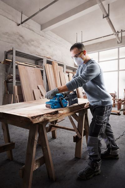 GBS 750 Bosch GBS 750 belt sander smoothing wooden plank.