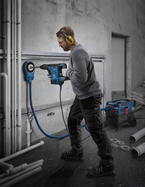 Bosch GBH 6-42 rotary hammer drilling into concrete wall.