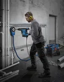 Bosch GBH 6-42 rotary hammer drilling into concrete wall.