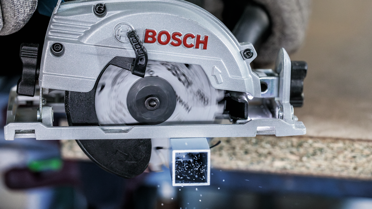 PRO Multi Material cordless Circular Saw Blade, 85 x 1.5 x 15 mm Person wearing safety equipment uses a circular saw to cut a metal square tube.