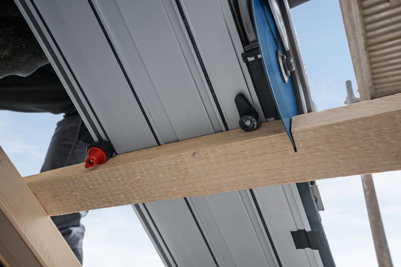 FSN 740 X Track saw cutting through a wooden beam on a construction site.
