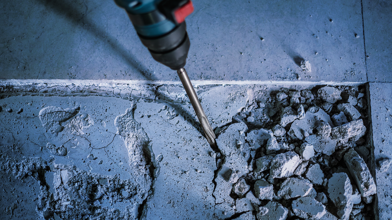PRO SDS plus-5C Pointed Chisel, 250 mm Rotary hammer breaking up concrete floor tiles.