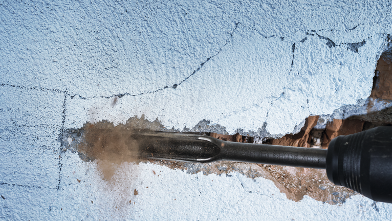 PRO SDS max Hollow Gouging Chisel, 26 x 300 mm Rotary hammer chiseling a groove in a plastered wall.