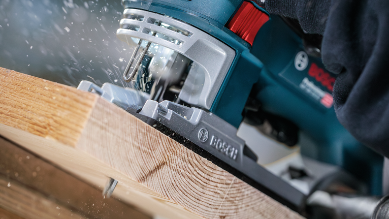 PRO Wood precise T144DP Jigsaw Blade, 100 mm, 5 pcs Person wearing safety equipment using a jigsaw to cut a wooden board.