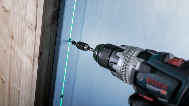 PRO PH Impact Bit, PH1 x 55, PH2 x 55, PH3 x 55 mm, 3 pcs Cordless drill driving a screw into a wall along a green laser guide.