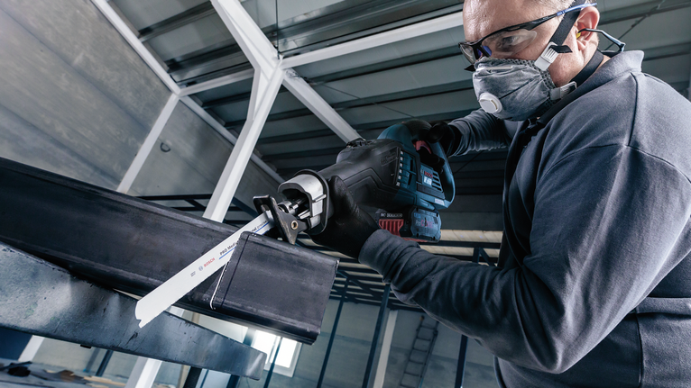 PRO Medium-Thick Metal precise S937BEF Blade, 1.1 x 25 x 150 mm, 5 pcs A person wearing safety equipment uses a reciprocating saw to cut a metal beam.