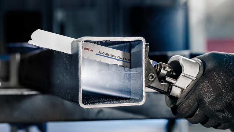 PRO Medium-Thick Metal precise S937BEF Blade, 1.1 x 25 x 150 mm, 5 pcs Person wearing safety equipment cuts a metal square tube with a power saw.