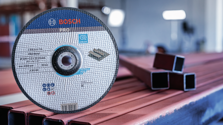 Cutting disc standing upright on metal beams in a workshop.