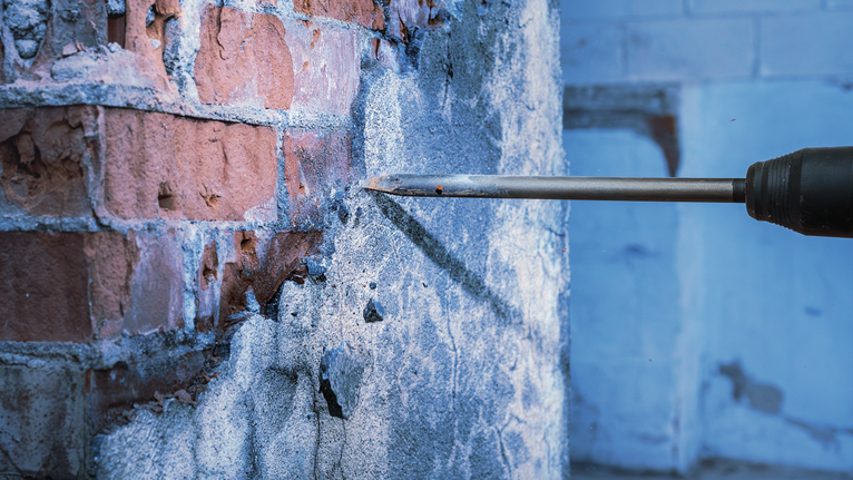 PRO SDS max-4C Pointed Chisel Set, 400 mm, 10 pcs Drill chisel breaking concrete from a brick wall.