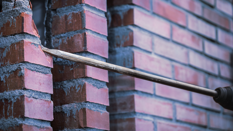 PRO SDS max-4C Pointed Chisel Set, 400 mm, 10 pcs Drill bit making a hole through a brick wall.