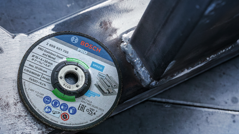 PRO Stainless Steel and Metal Grinding Disc, 76 x 4 x 10 mm Cutting disc placed on a welded metal frame.
