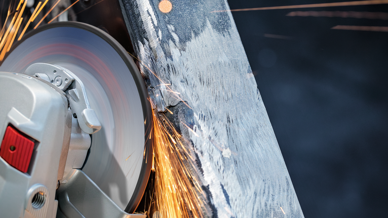 PRO Metal Grinding Disc, A 24 S BF, 180 x 6.6 x 22.23 mm, Depressed Centre Cutting wheel generates sparks while cutting through a metal beam.