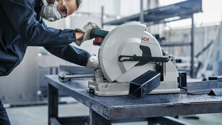 PRO Steel Circular Saw Blade, Corded, 254 x 2.2 x 25.4 mm, T52 A worker wearing safety equipment cuts a metal beam with a circular saw.