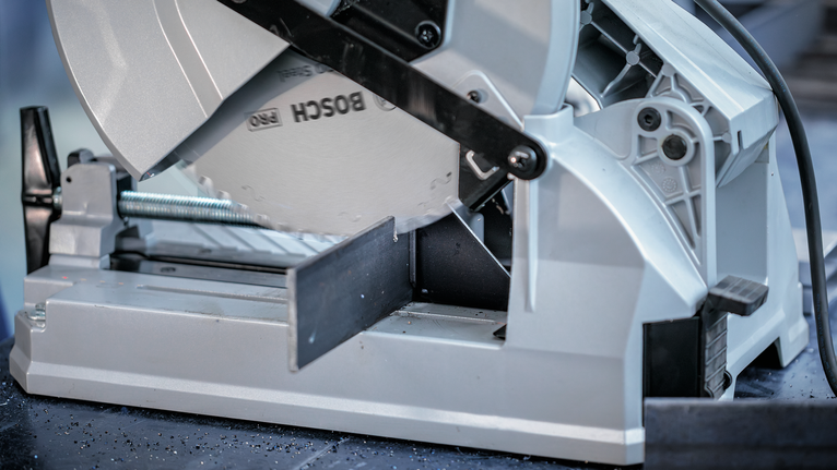 PRO Steel Circular Saw Blade, Corded, 254 x 2.2 x 25.4 mm, T52 Metal cutting saw blade slices through a steel bar in a workshop setting.