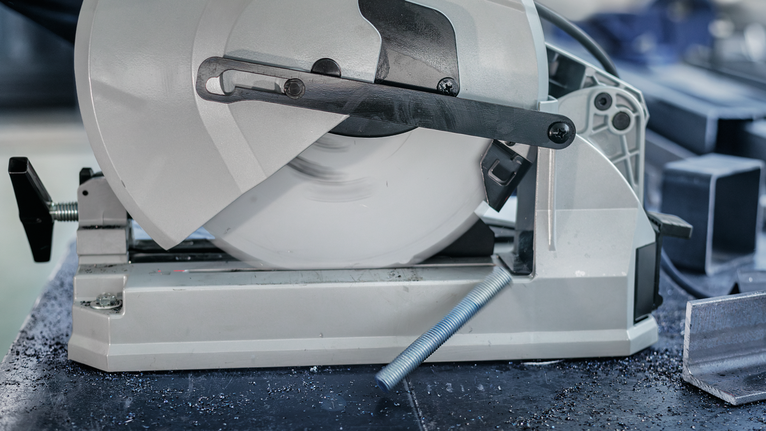 PRO Steel Circular Saw Blade, Corded, 254 x 2.2 x 25.4 mm, T52 Metal cutting saw slicing through a steel rod in a workshop.