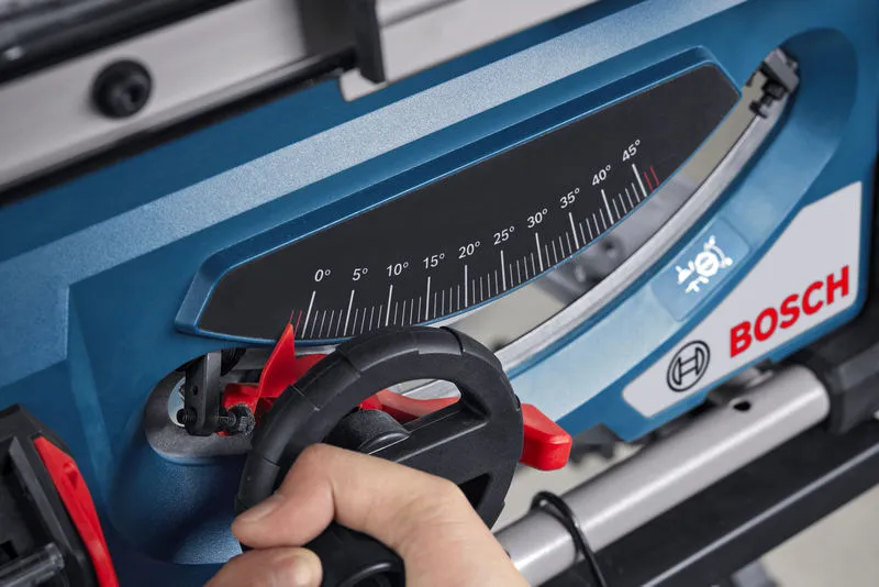 A person adjusts the angle gauge on a blue table saw.
