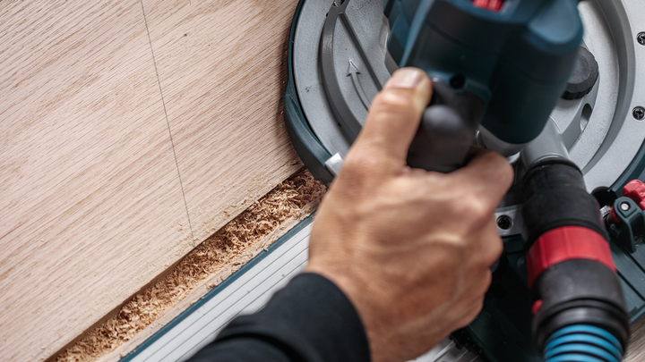 Object #200587710: 7437791_app_web_01 Person operates a circular saw to cut wood along a straight line.