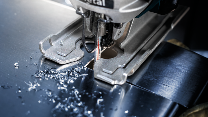 Object #200597849: 2793293_app_web_01 Jigsaw cutting a precise hole through a shiny metal sheet.