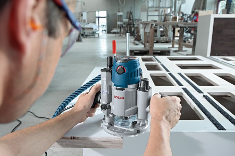 GOF 1600 CE A person wearing safety equipment uses a router to shape the edge of a wooden board.